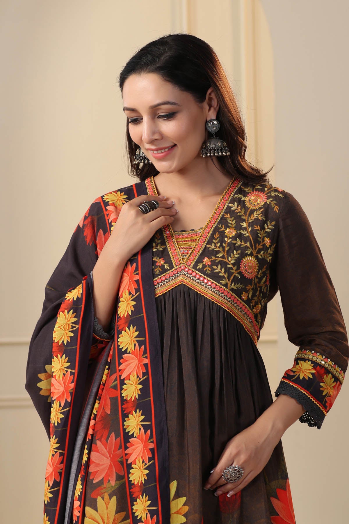 Woman wearing a traditional outfit with floral patterns on a beige background