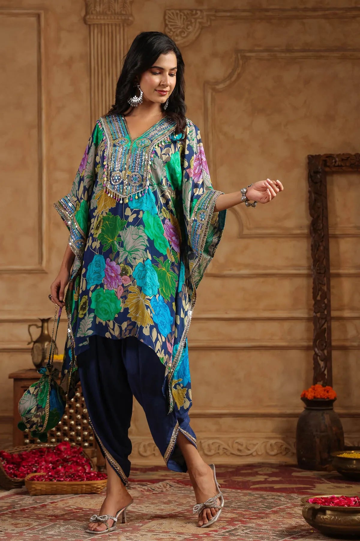 Woman wearing a colorful traditional outfit in an ornate room.