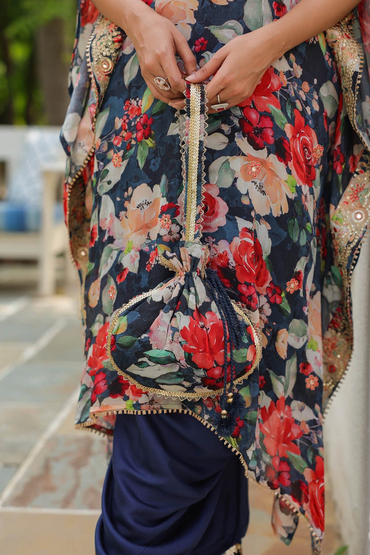 Floral patterned garment with intricate details and a blue drape.