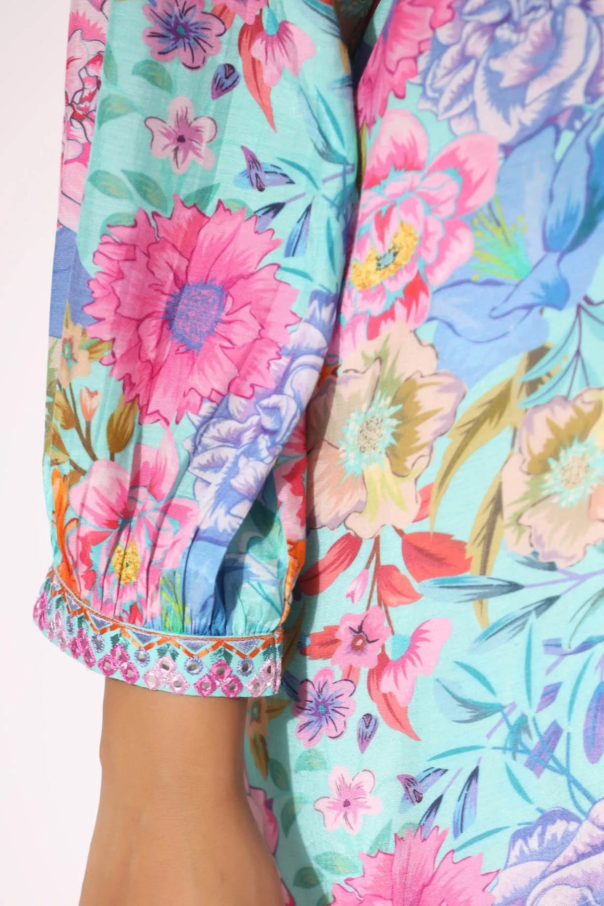 Close-up of a colorful floral patterned garment with bright pink and blue flowers.
