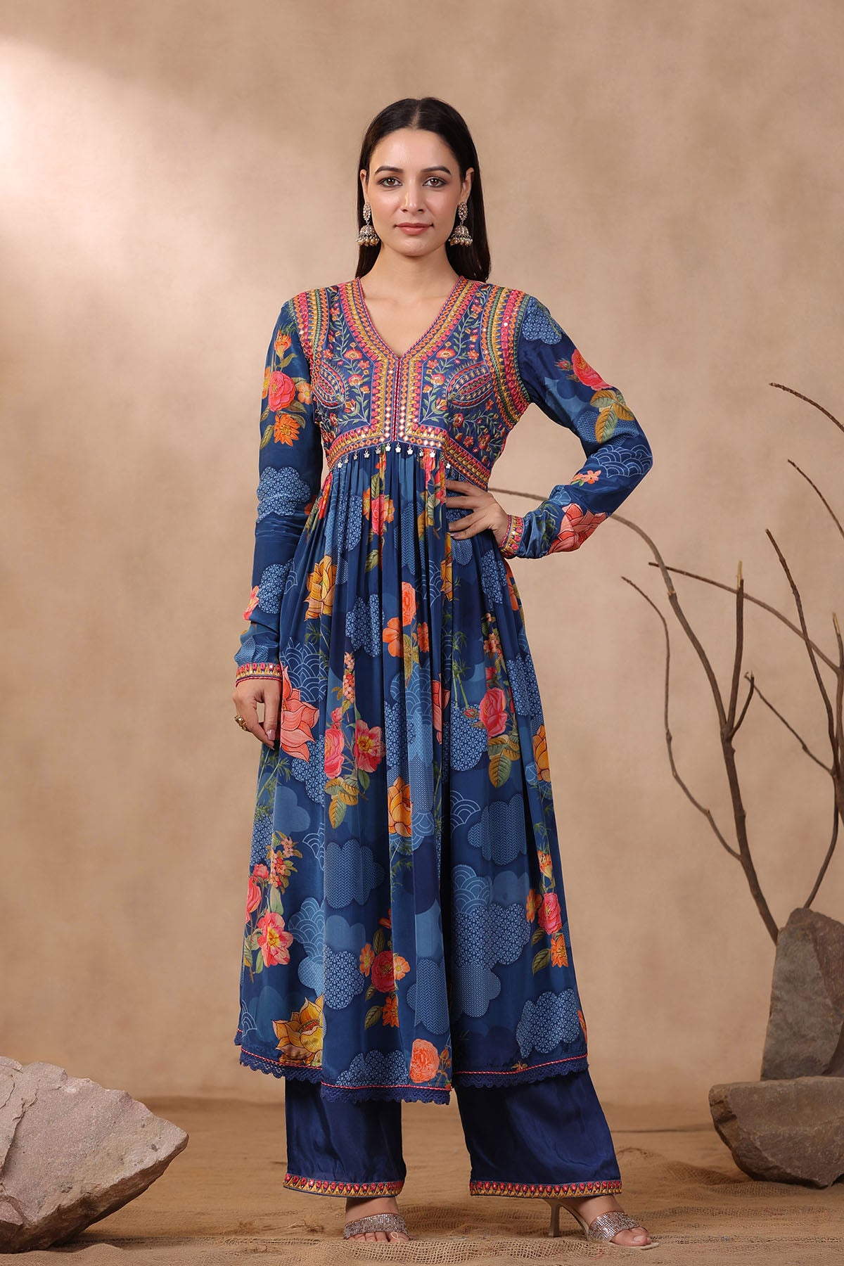 Woman wearing a blue floral traditional outfit against a beige background