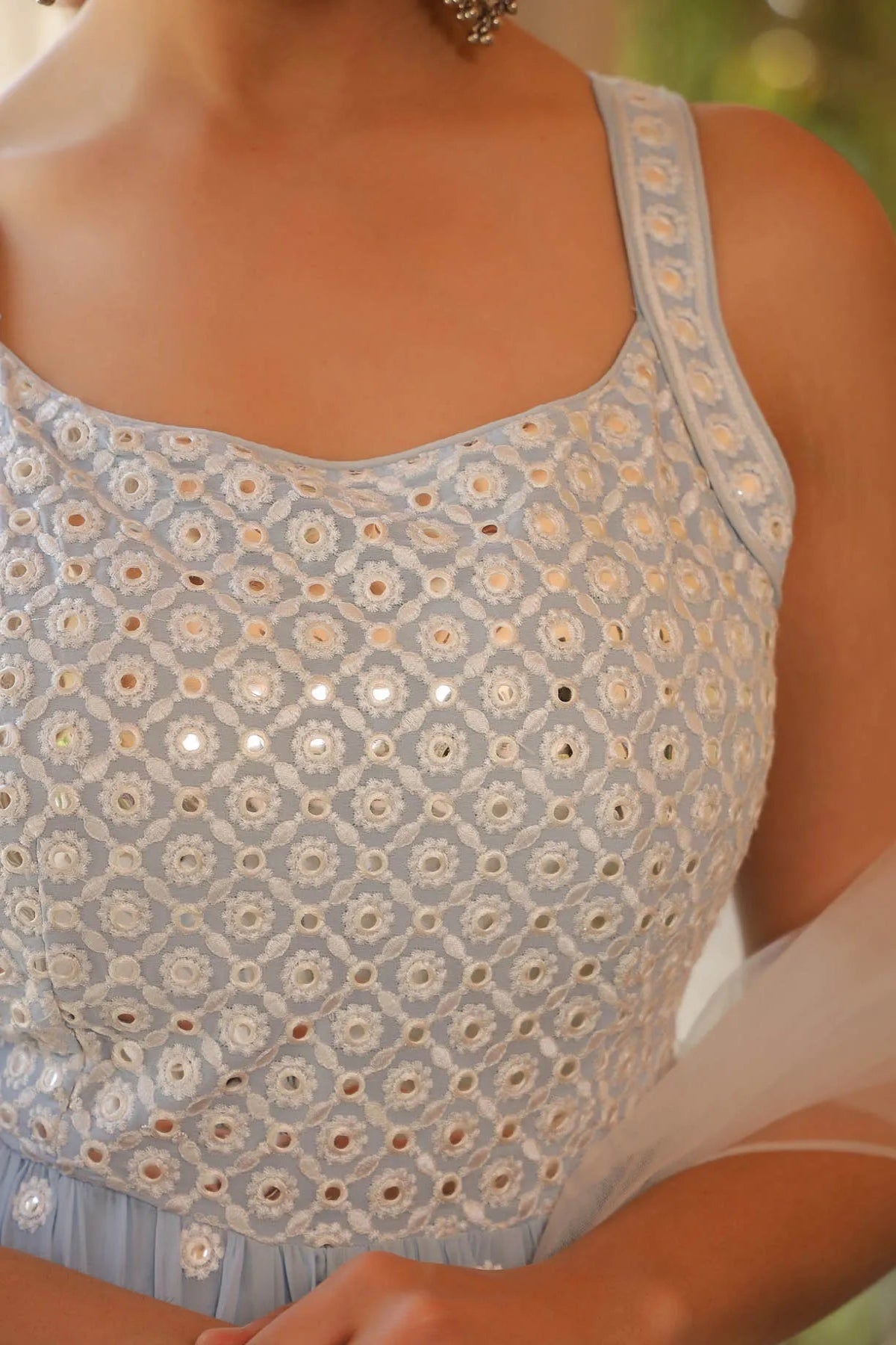 Close-up of a light blue floral patterned top with a blurred background