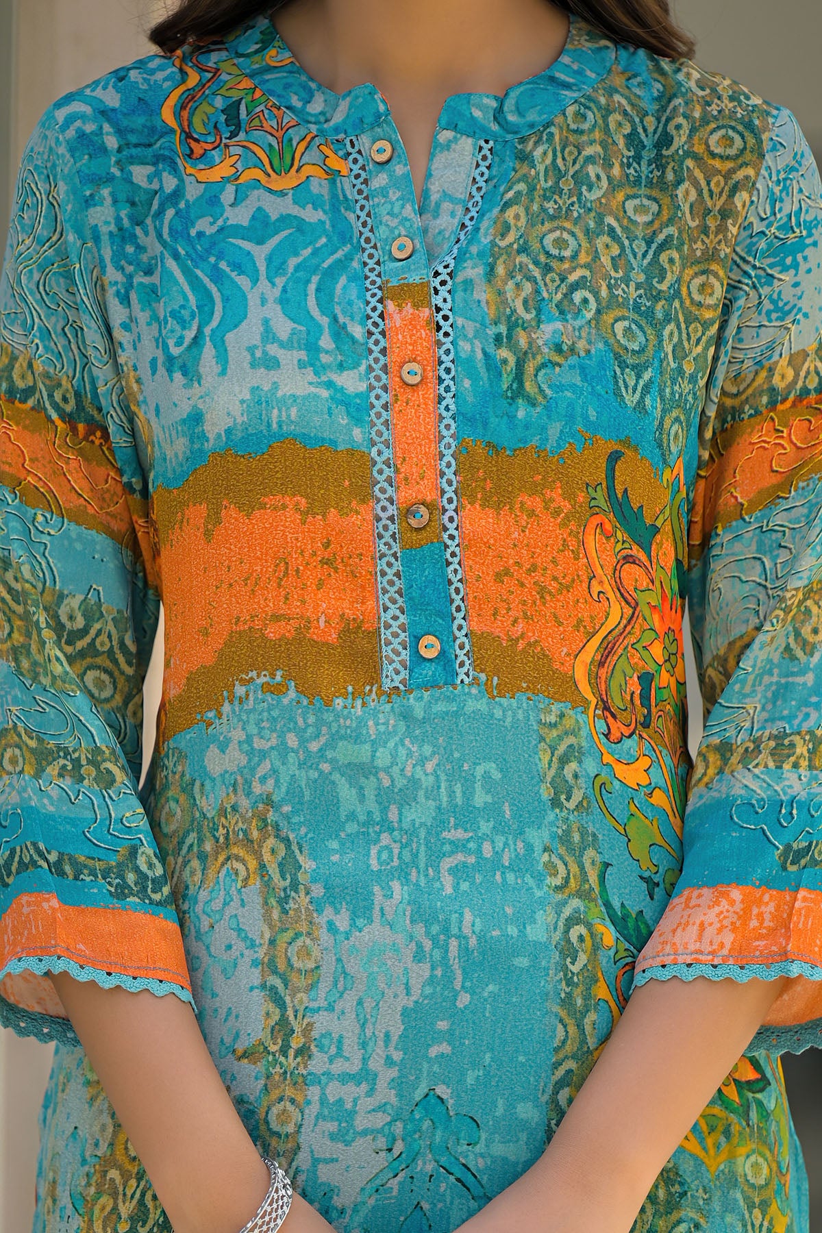 Turquoise and orange patterned shirt with intricate designs