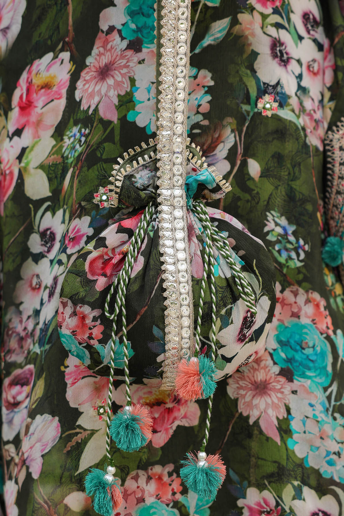 Close-up of a decorative zipper on a floral-patterned fabric background