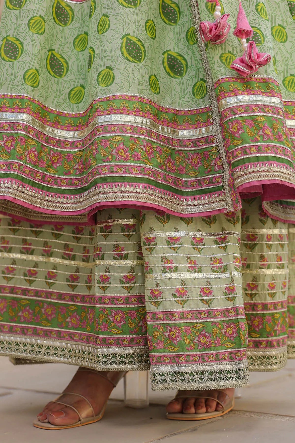 Traditional green and pink embroidered outfit with floral patterns