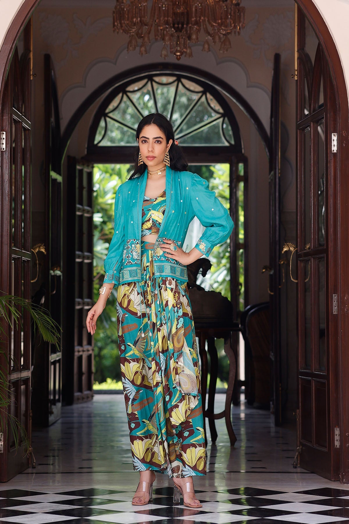 Woman in a colorful outfit standing in a decorated hallway