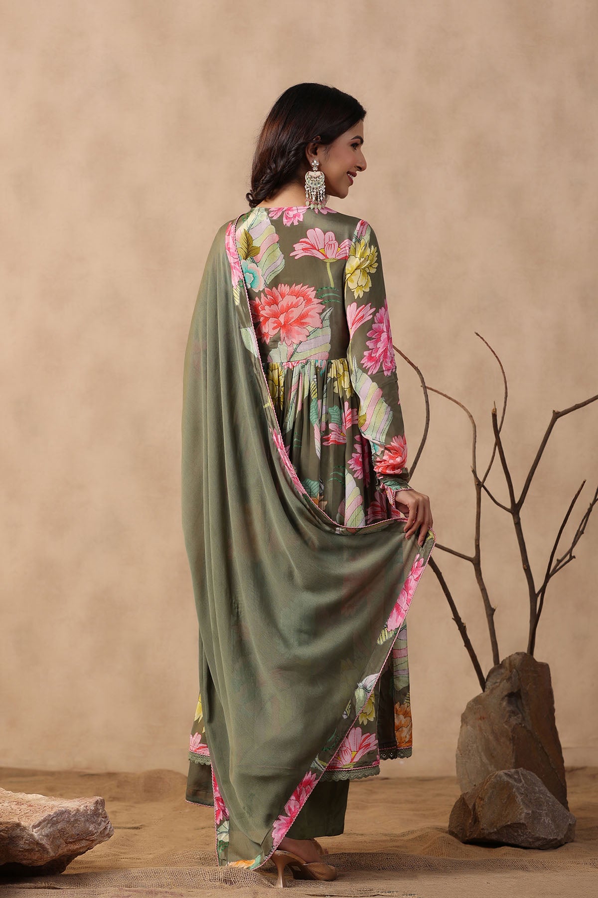 Woman wearing a floral dress with a beige background