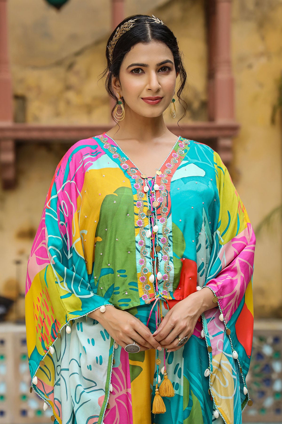 Woman wearing a colorful traditional outfit with a patterned background