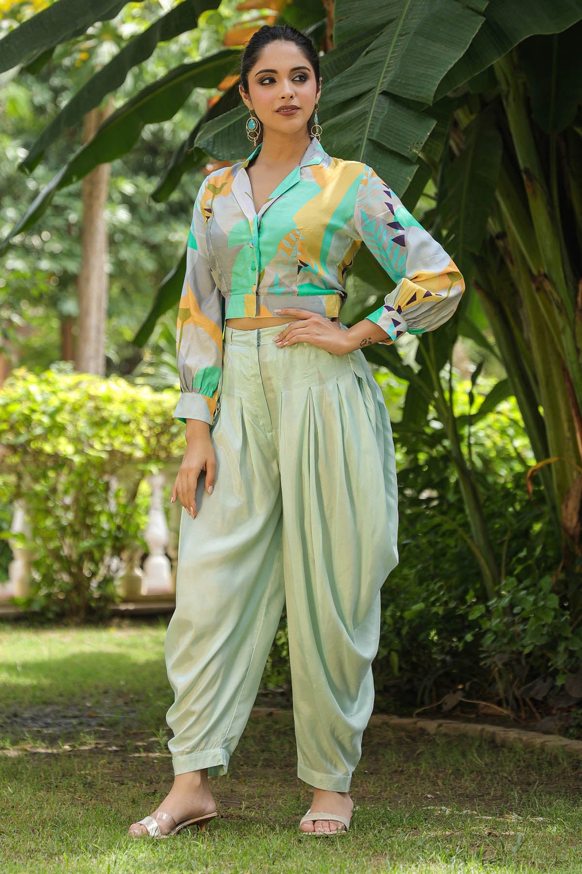 Woman in a colorful outfit standing in a garden