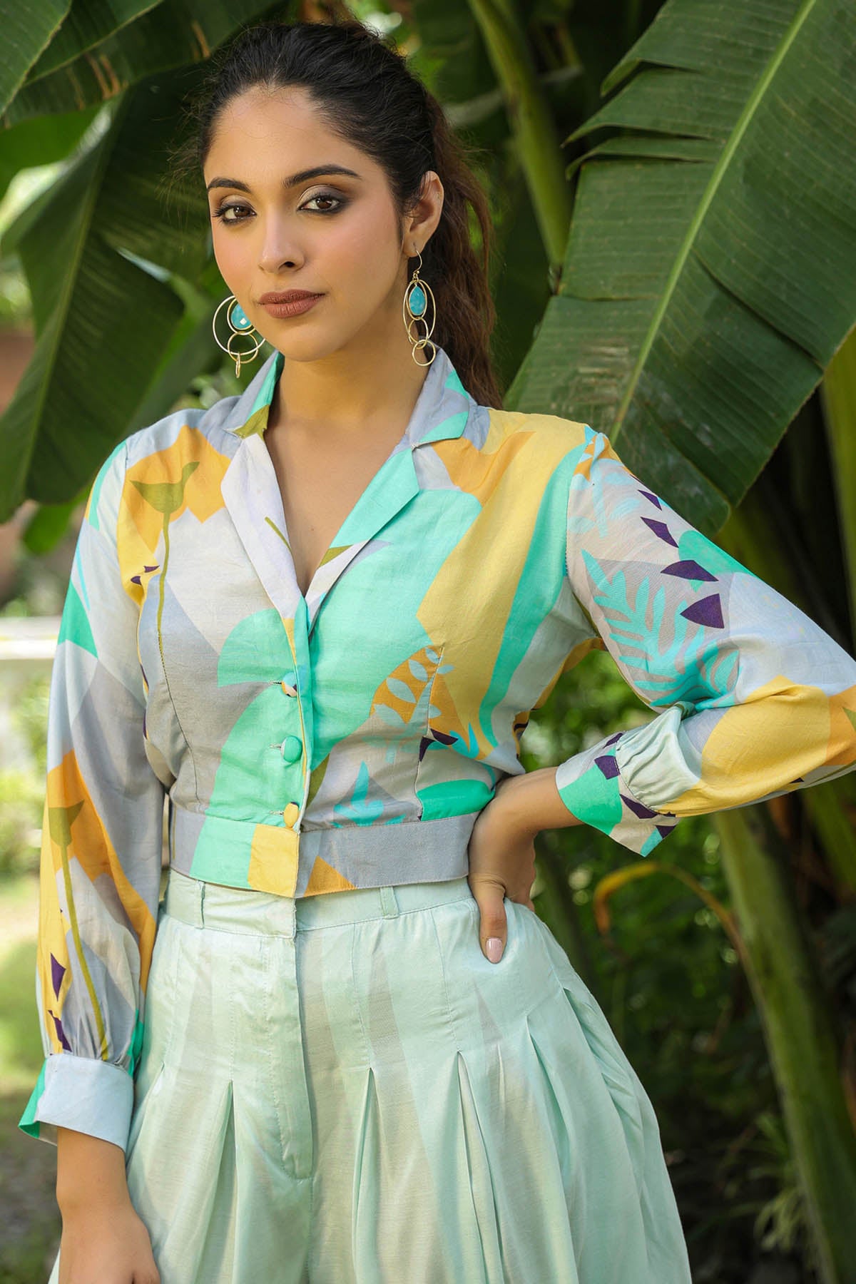 Woman wearing a colorful shirt with abstract patterns in a natural setting