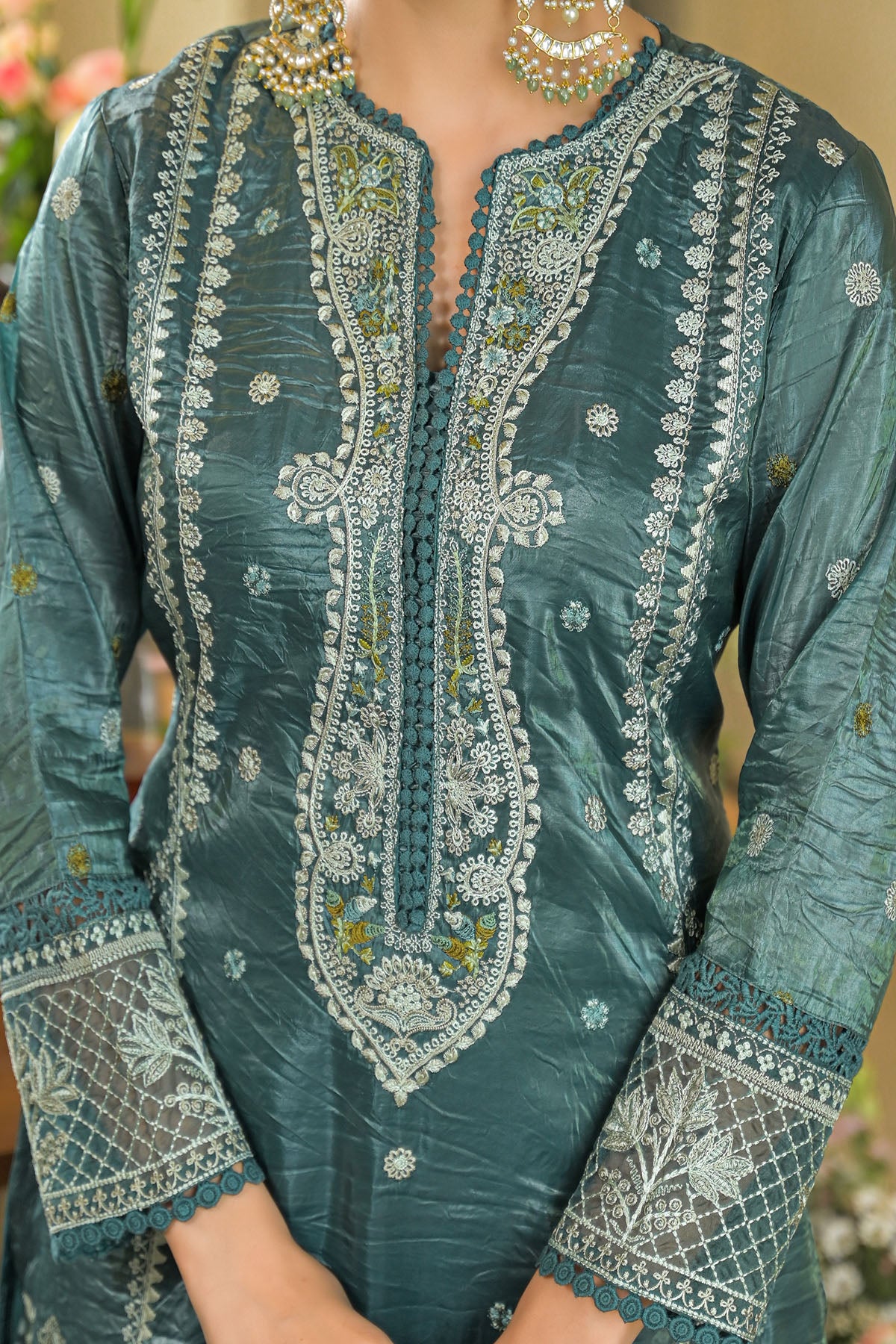 Teal embroidered traditional outfit with intricate patterns