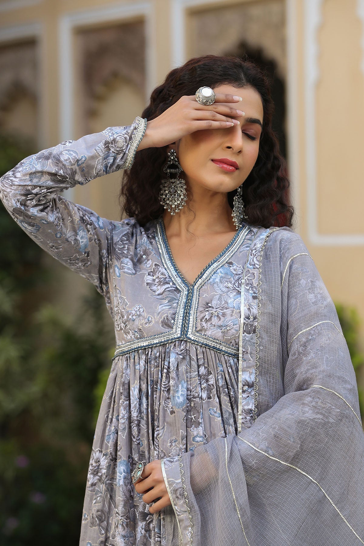 Woman wearing a silver sequin dress with a blurred background