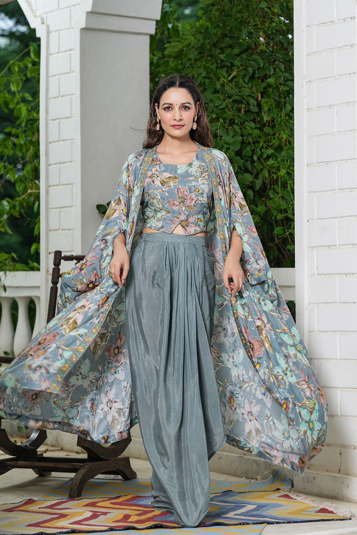 Woman wearing a floral and solid outfit standing outdoors.