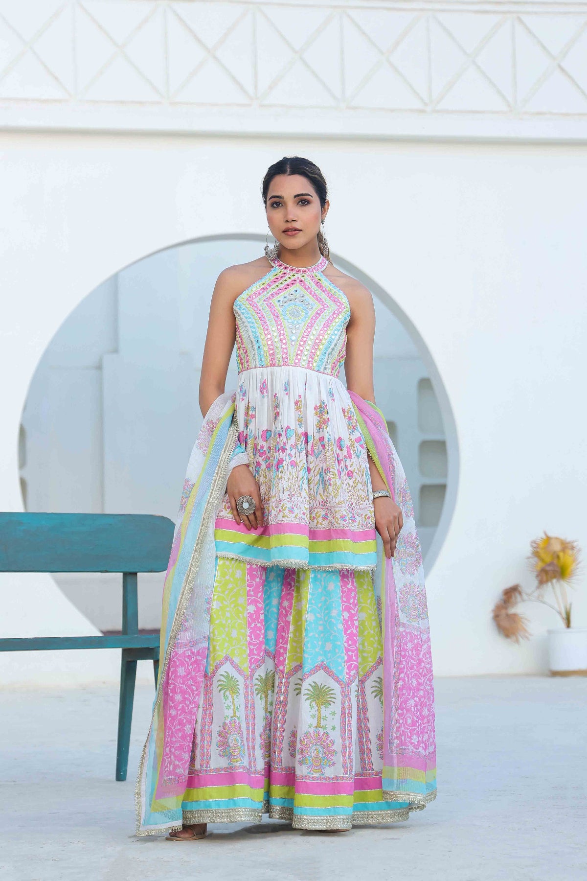 Woman wearing a colorful traditional outfit with a white background