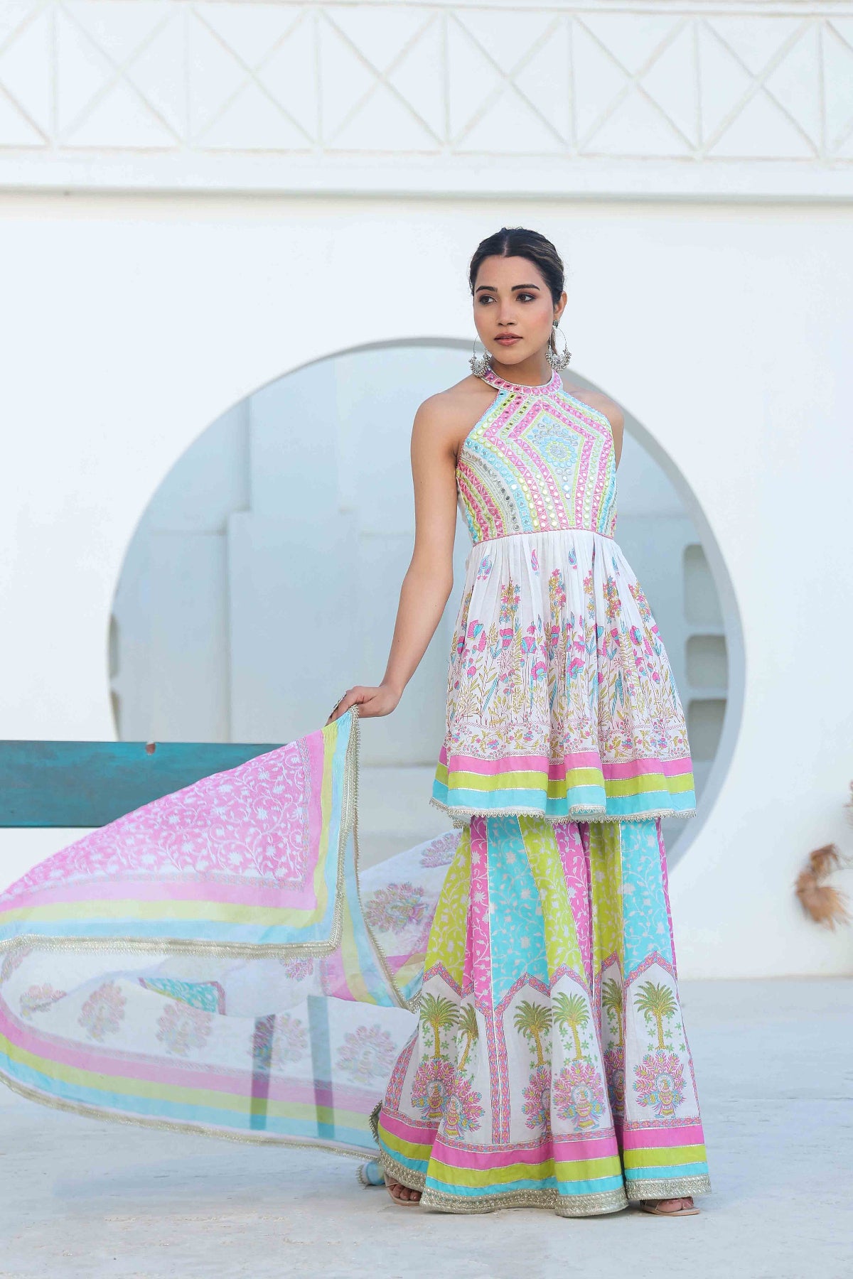 Woman wearing a colorful dress with a white background