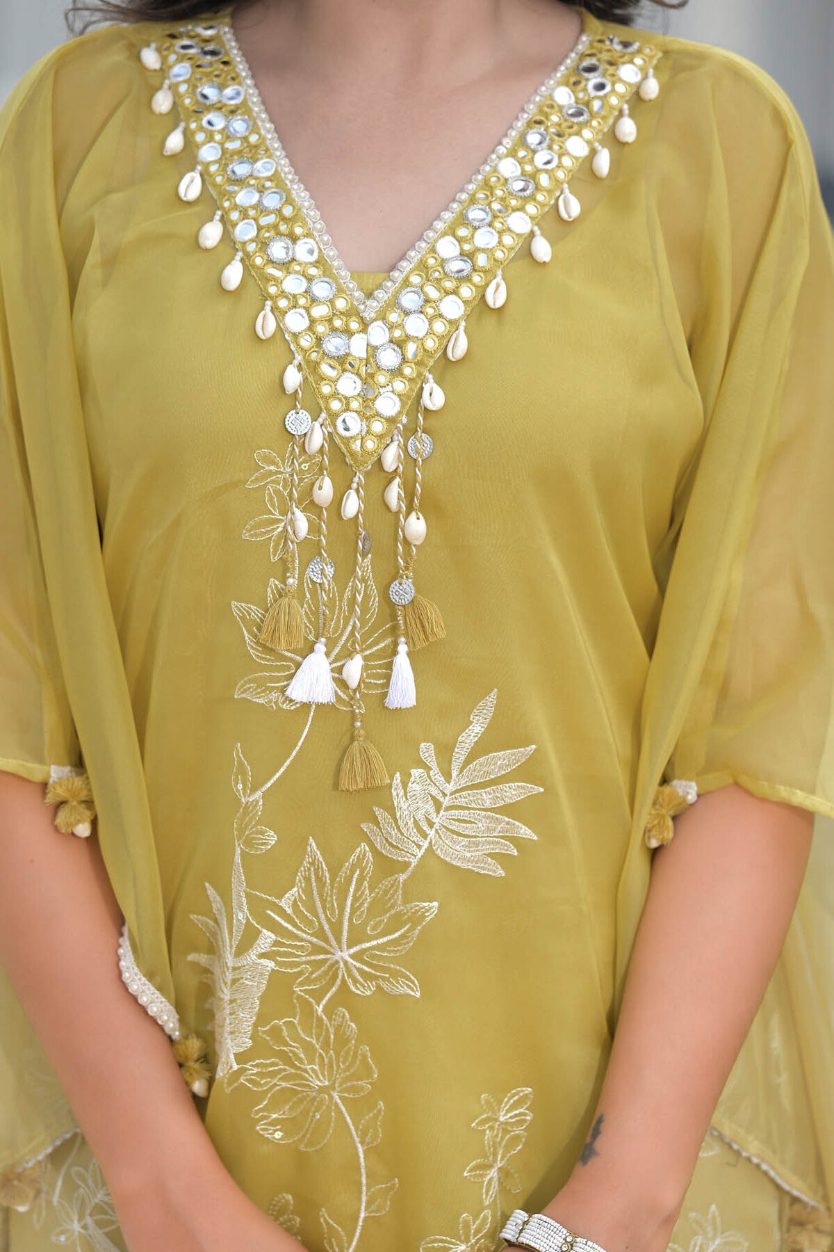 Yellow embroidered dress with intricate patterns and embellishments.