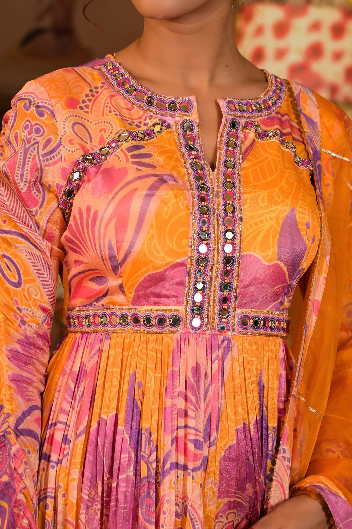 Close-up of a colorful dress with intricate patterns and embellishments.