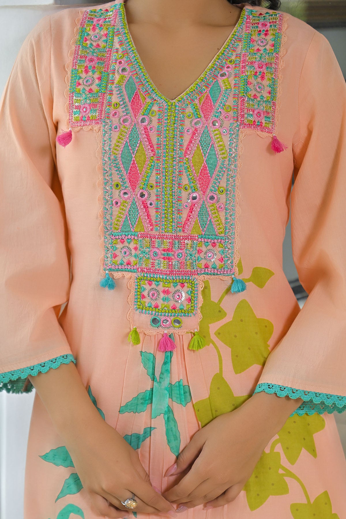 Pink traditional outfit with colorful embroidery and patterns