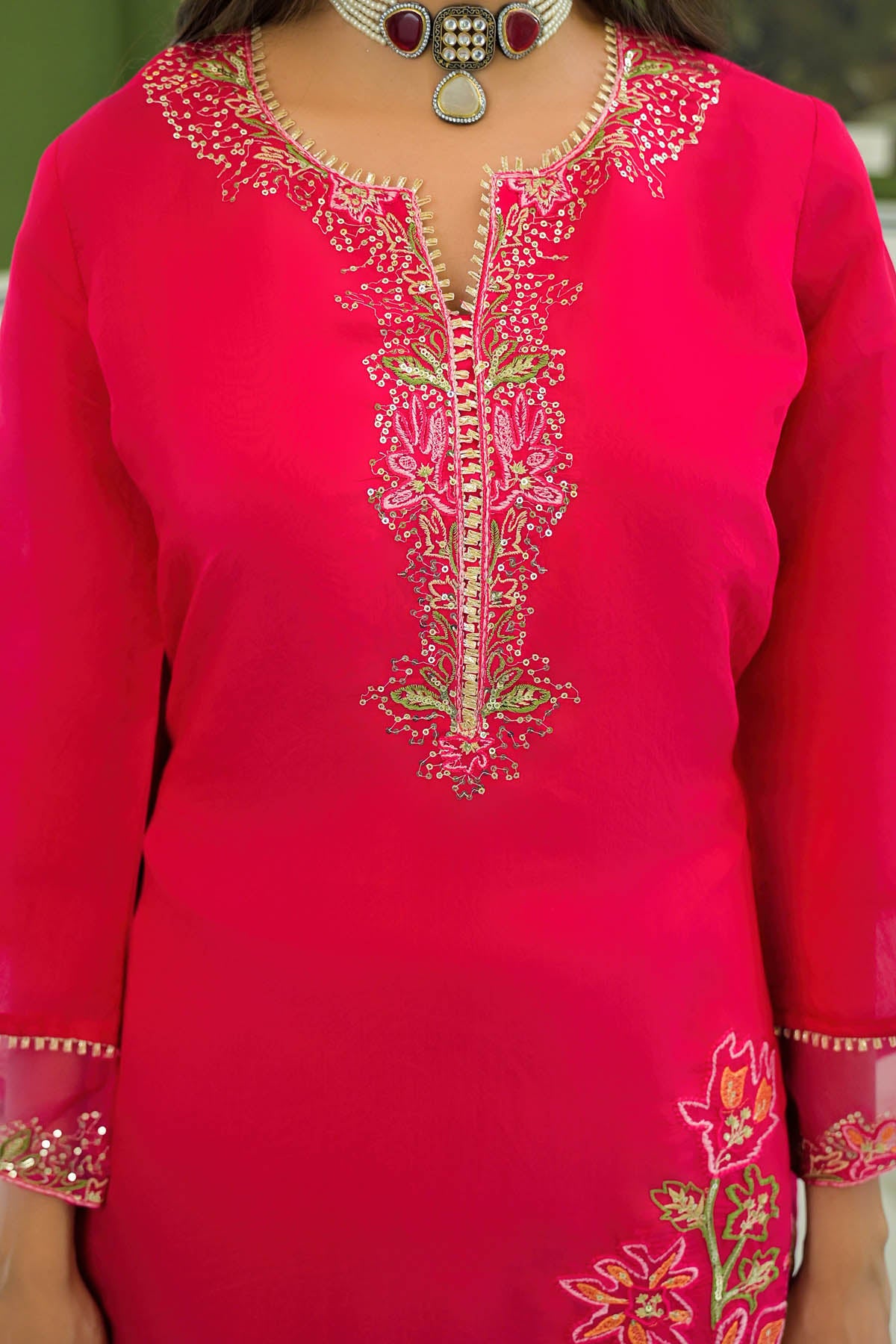 Red embroidered traditional outfit with intricate patterns
