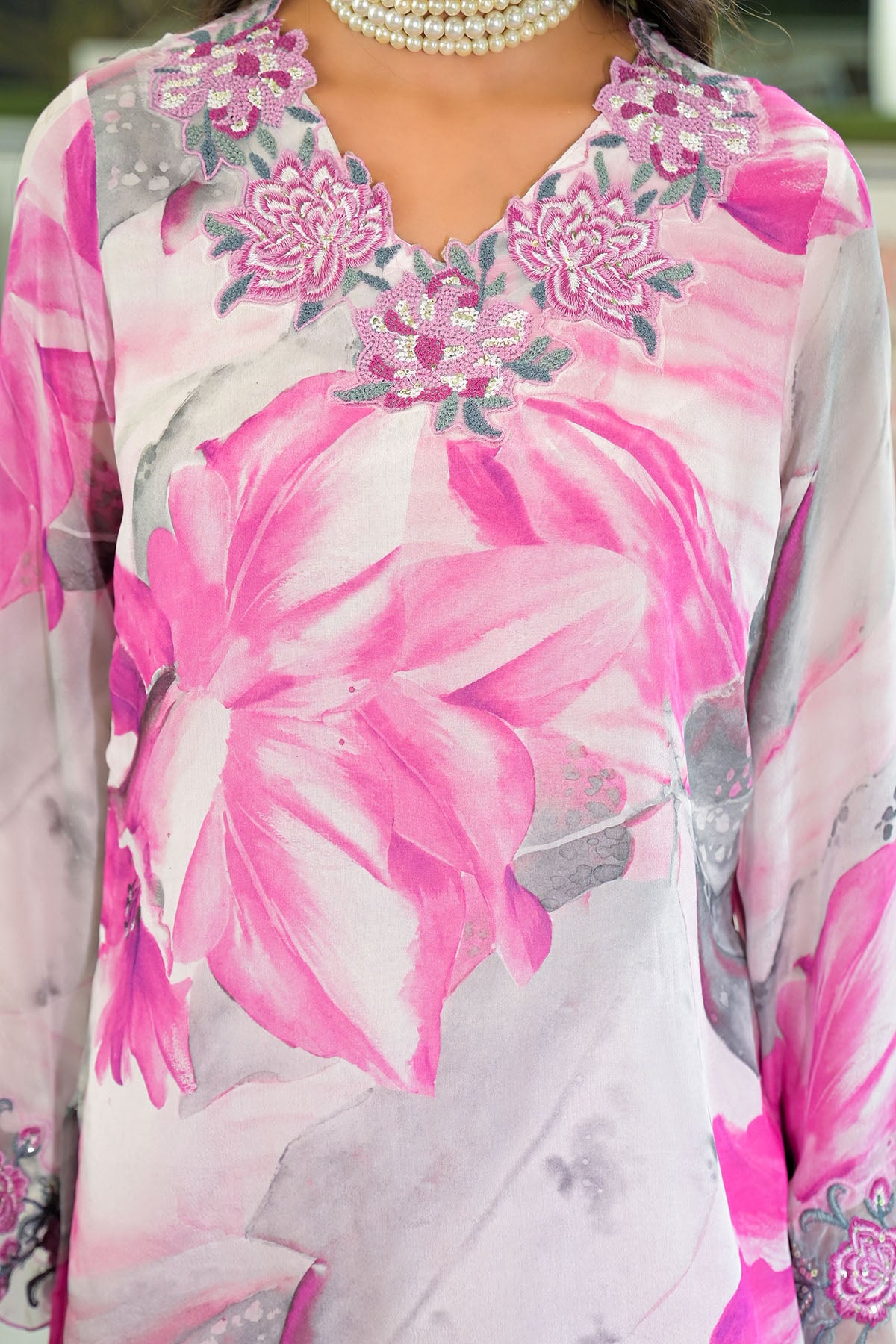 Floral patterned garment with pink and gray flowers on a light background