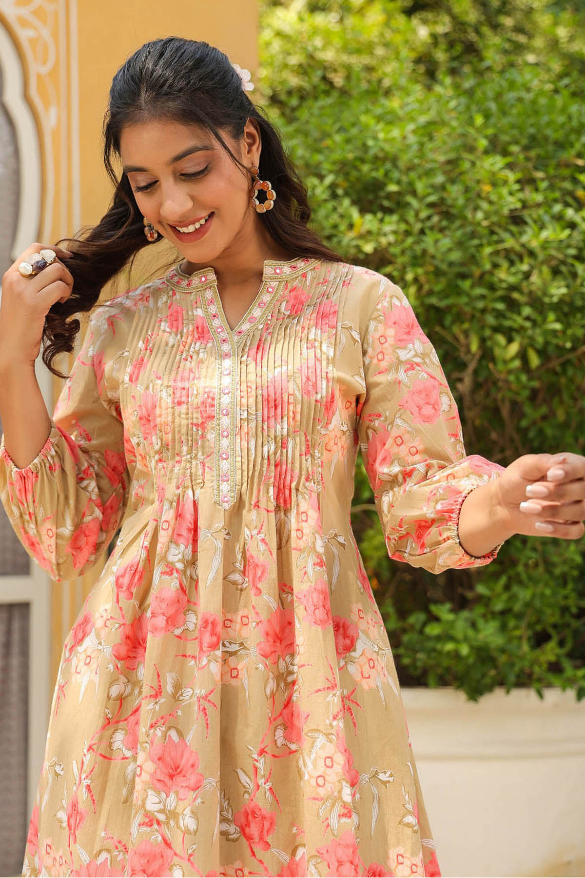 Woman wearing a floral dress with a blurred outdoor background