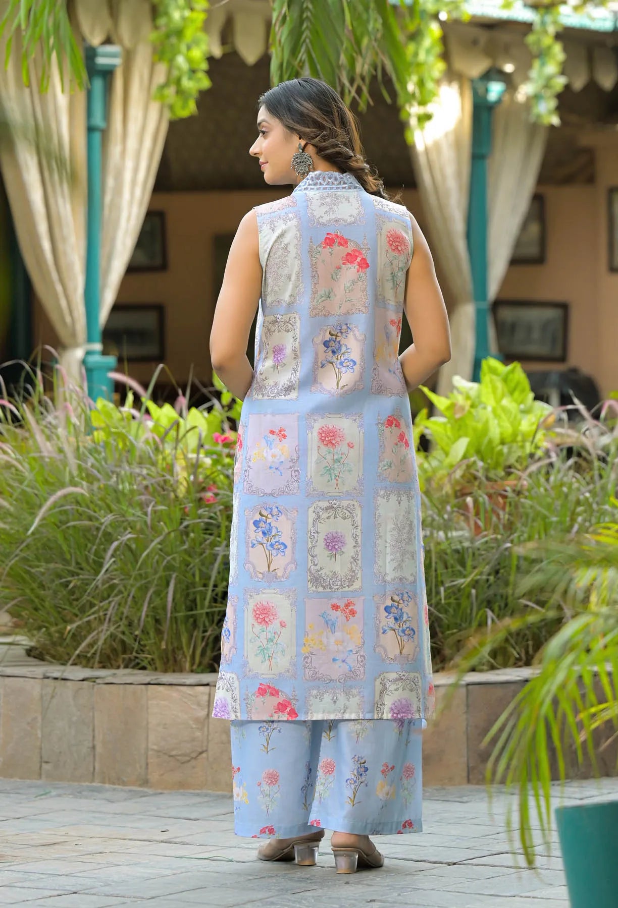 Woman wearing a floral dress with a garden background