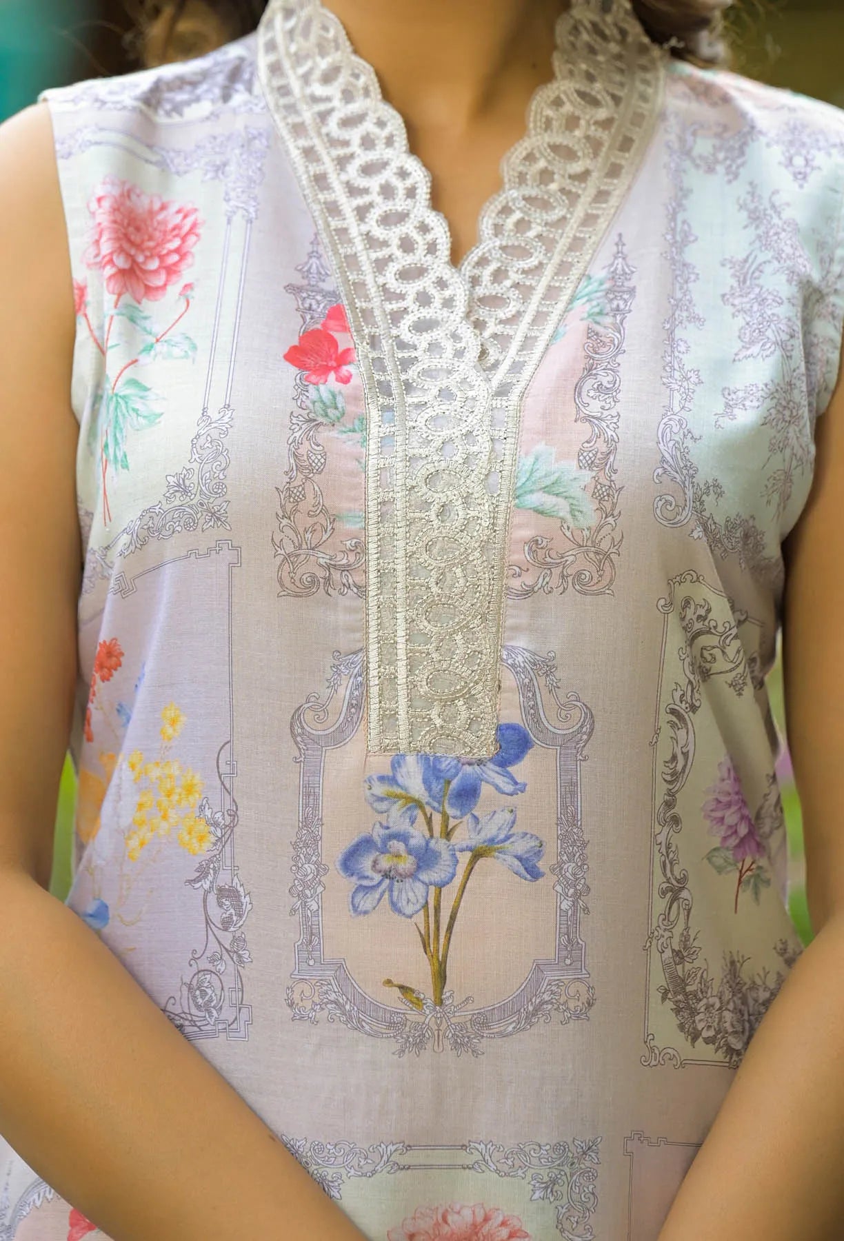 Close-up of a floral embroidered sleeveless top with lace details.