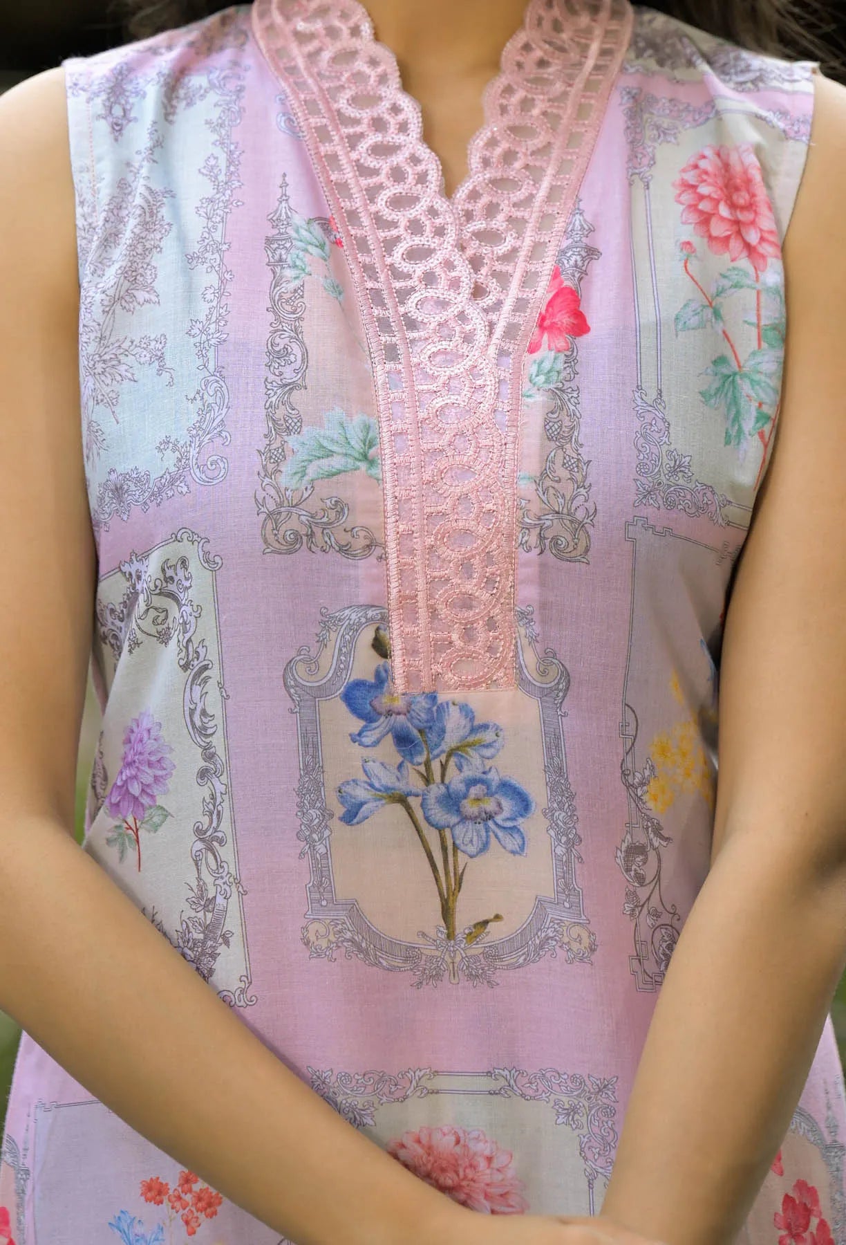 Close-up of a sleeveless top with floral and lace details