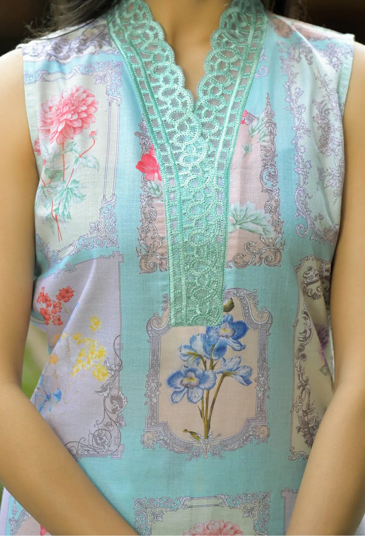 Light blue sleeveless top with floral patterns and embroidery on a mannequin.