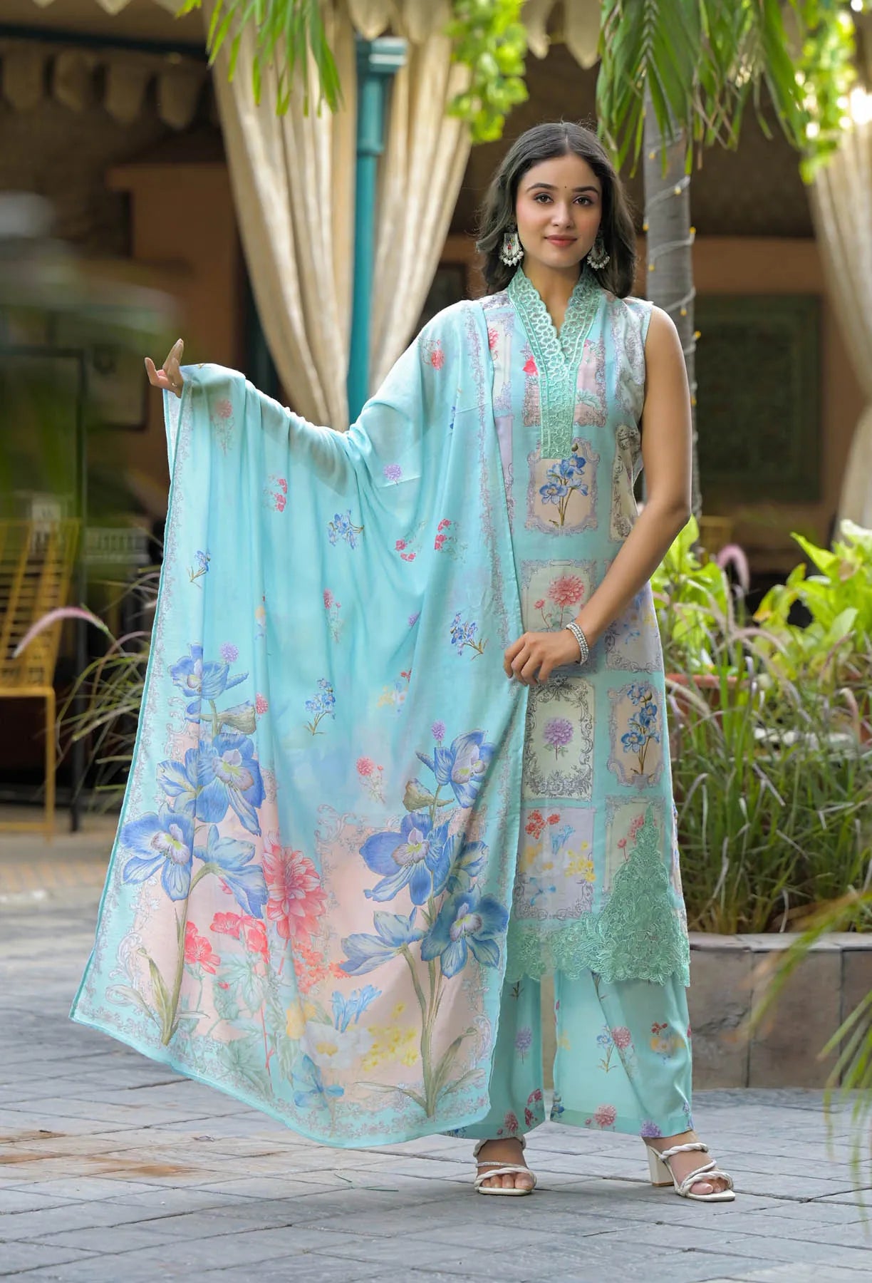 Woman holding a floral scarf in an outdoor setting