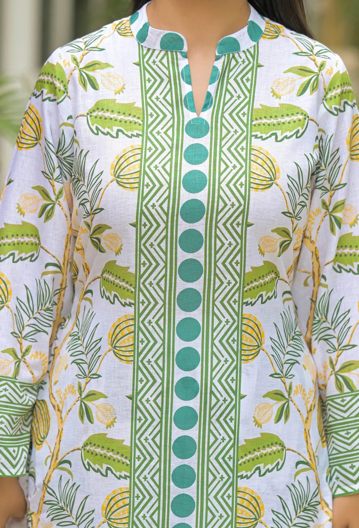 Green and white patterned shirt with floral and geometric design