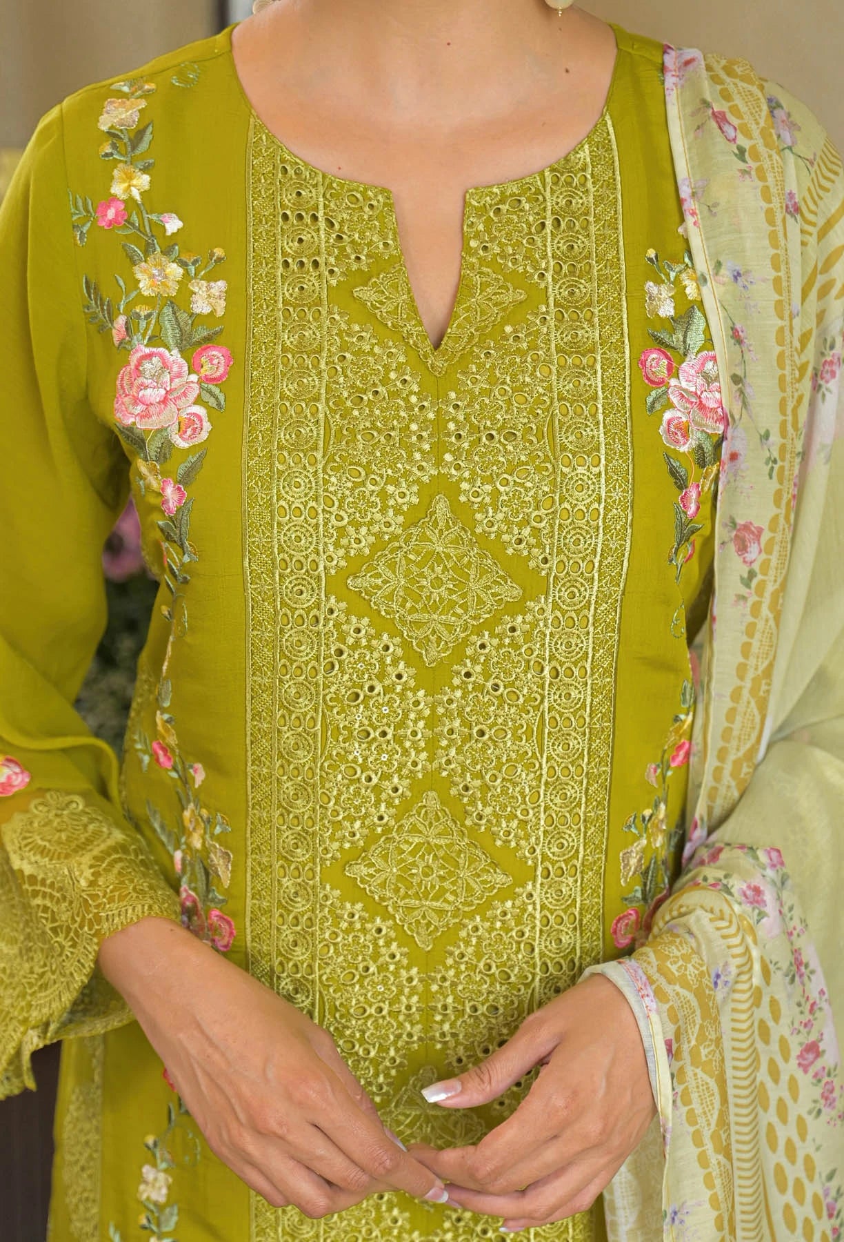 Green embroidered traditional outfit with floral patterns