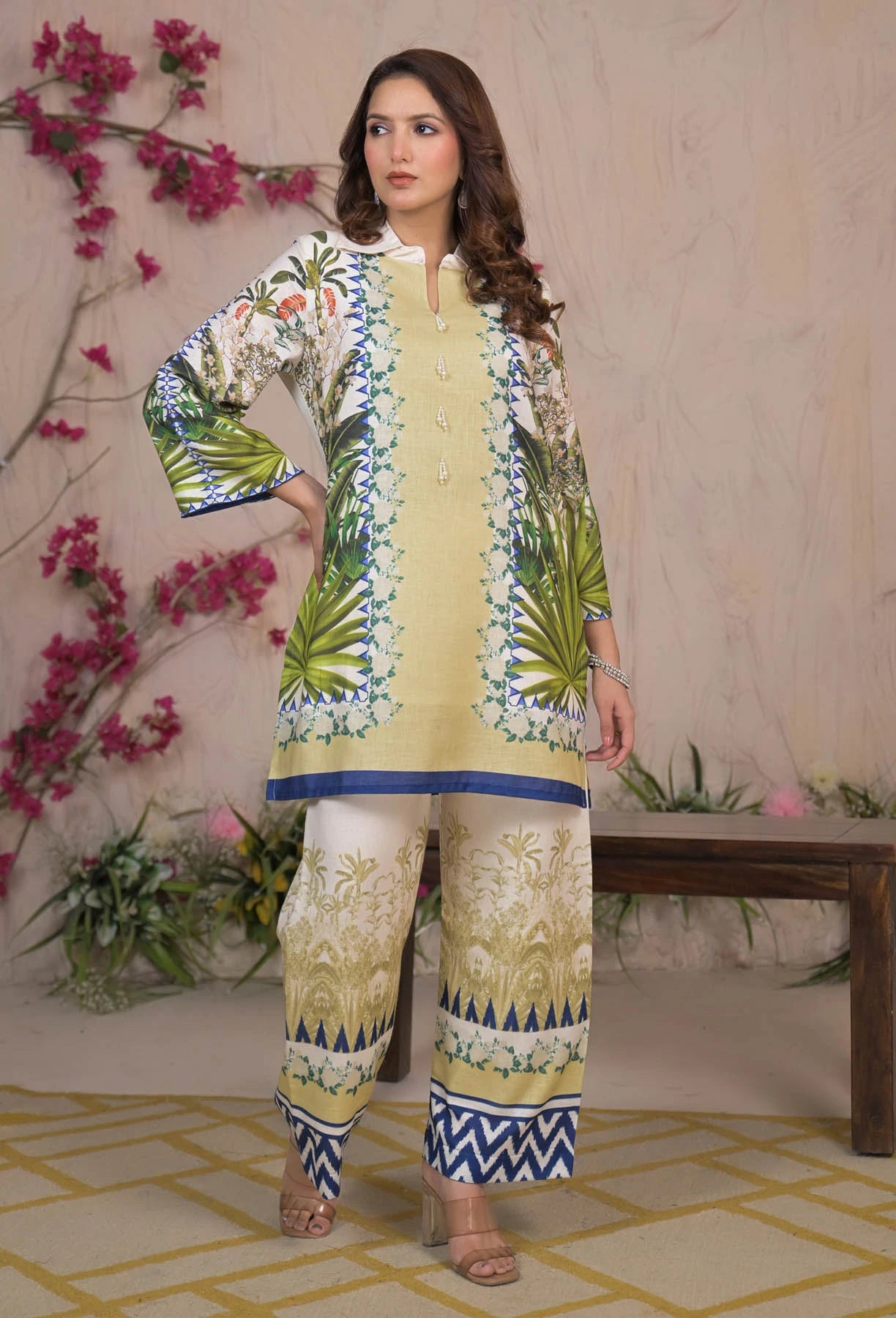Woman wearing a yellow embroidered outfit with floral background