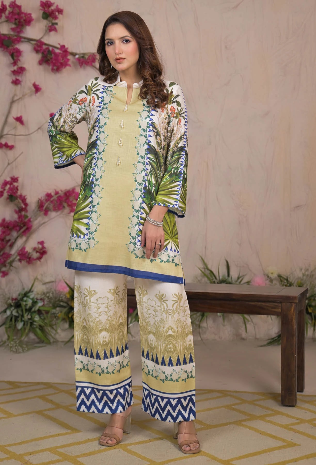 Woman wearing a patterned outfit with a floral background