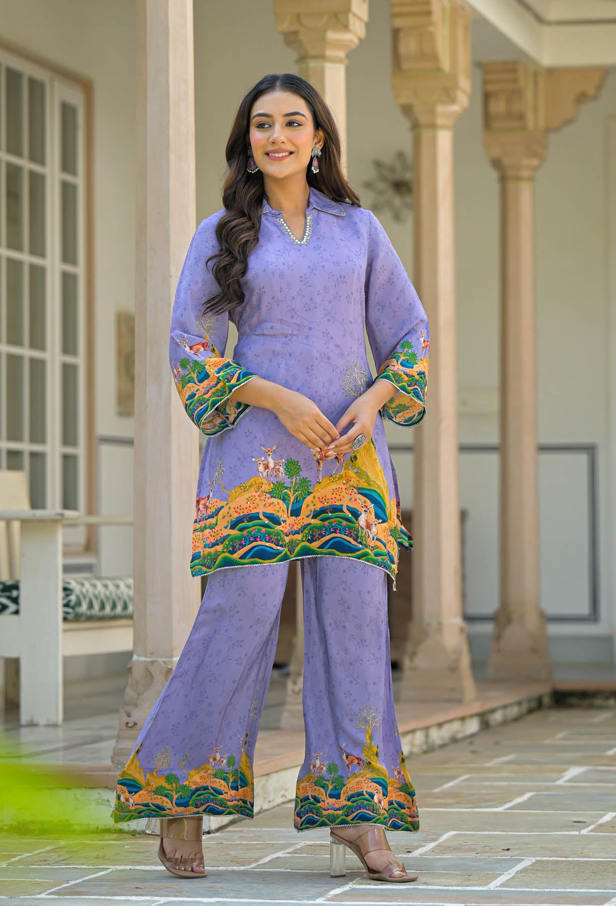 Woman wearing a lavender traditional outfit with colorful embroidery in an outdoor setting.