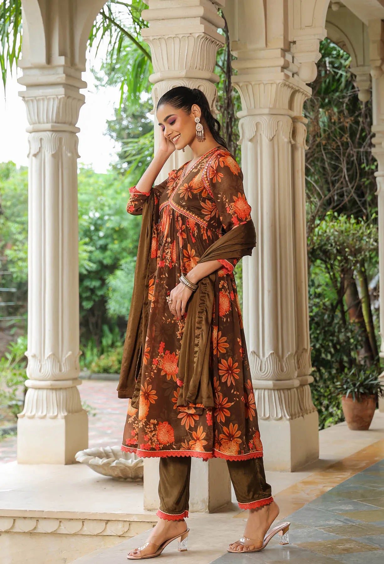 Woman in a floral dress standing in front of classical architecture