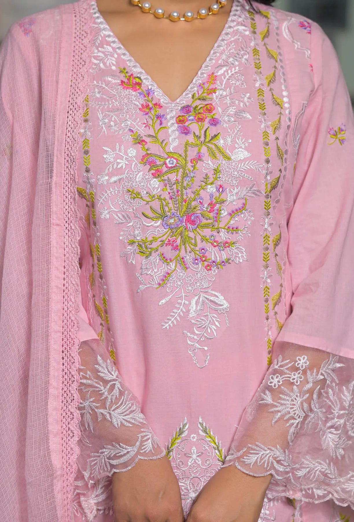 Pink embroidered outfit with floral patterns