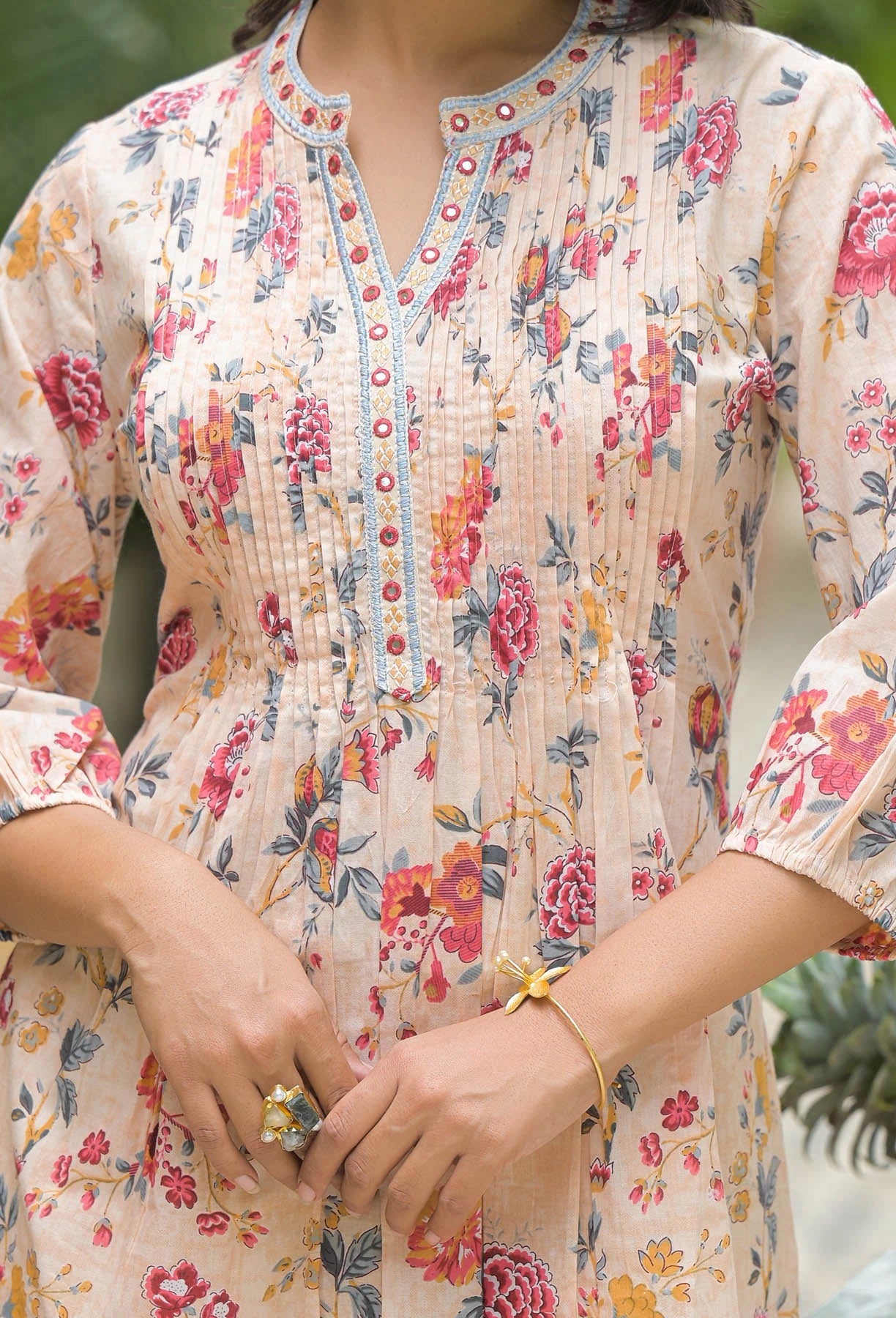 Person wearing a floral dress with a blurred background