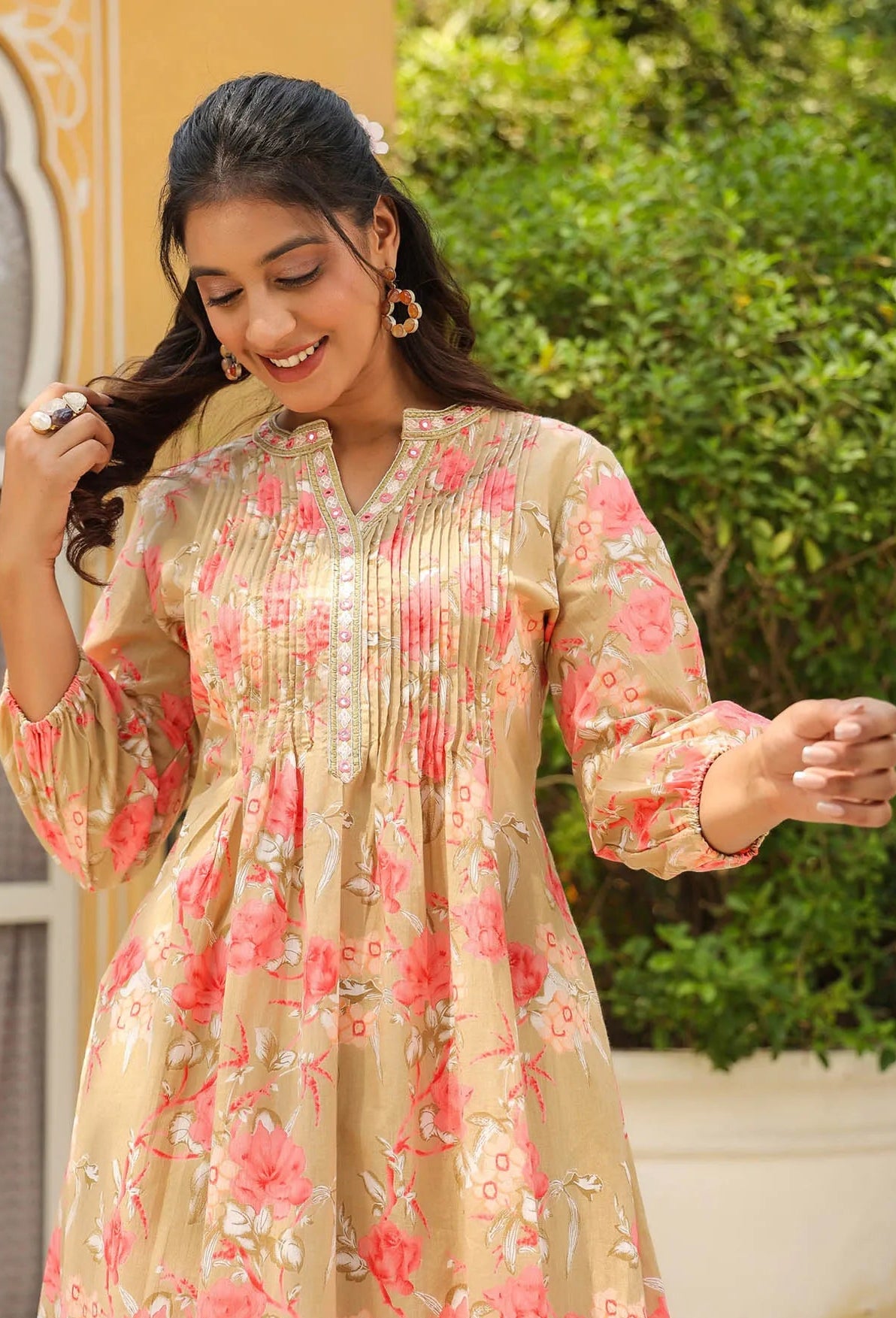 Woman wearing a floral dress with a blurred outdoor background