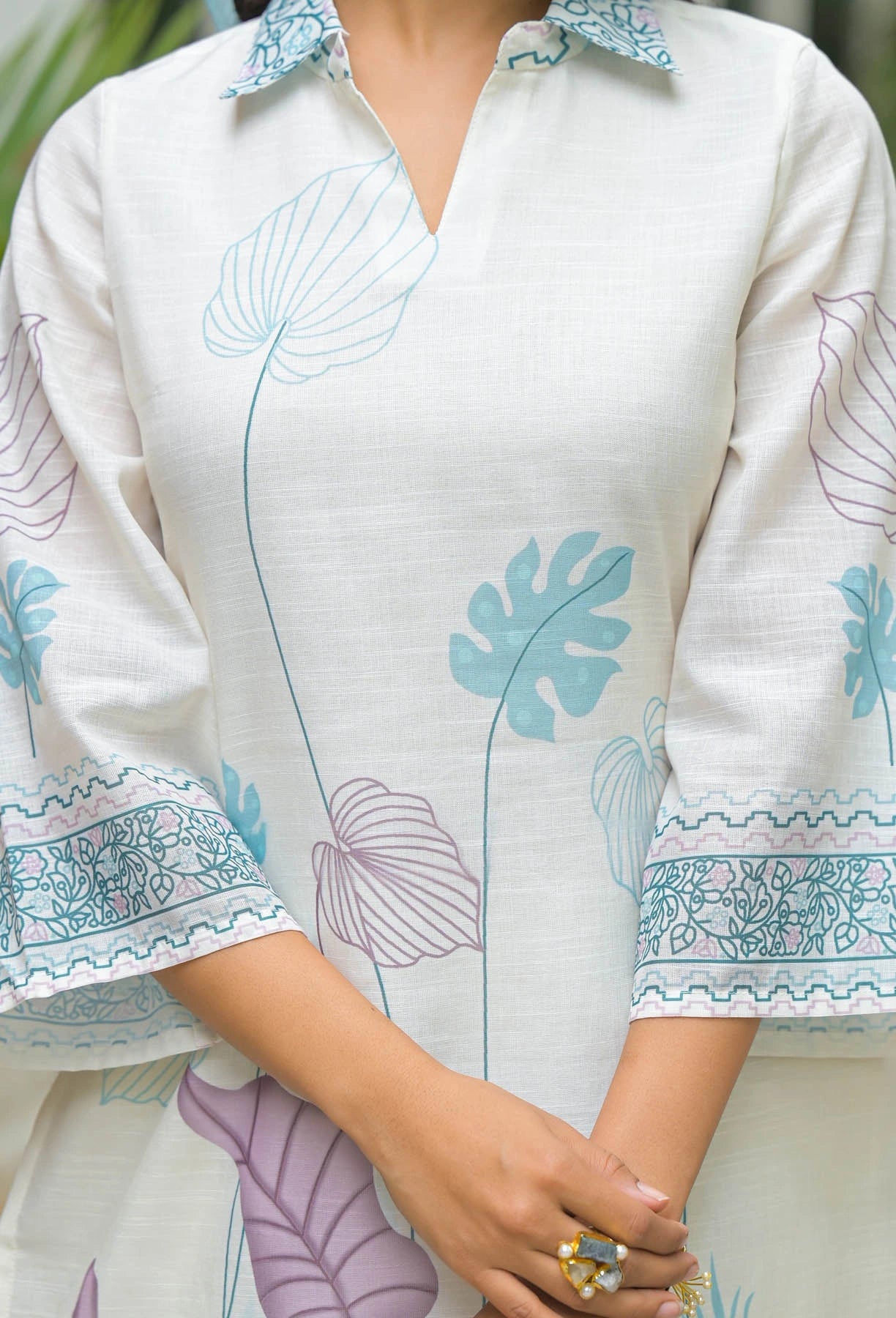 White shirt with blue floral patterns on a blurred background