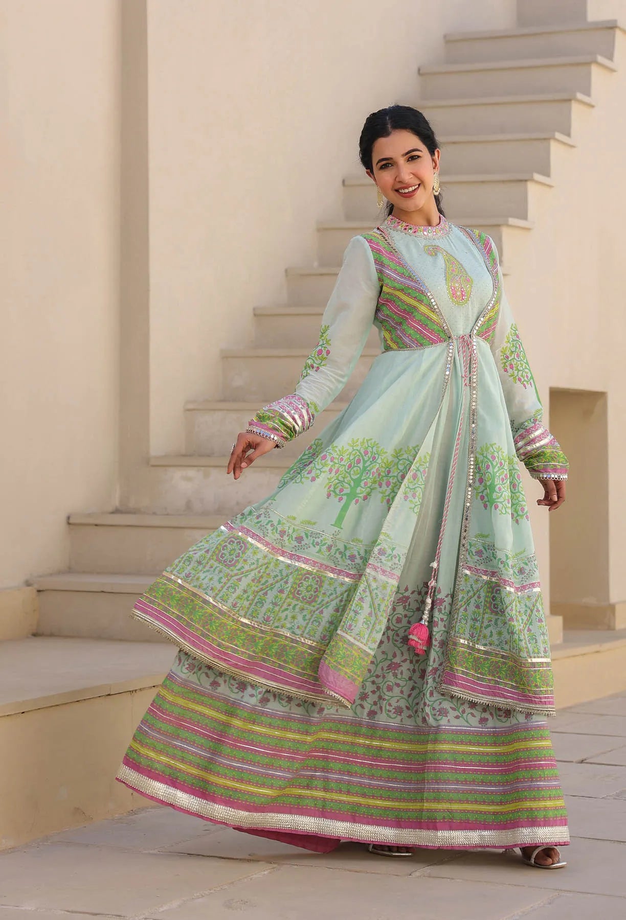 Woman in a traditional outfit standing on a staircase