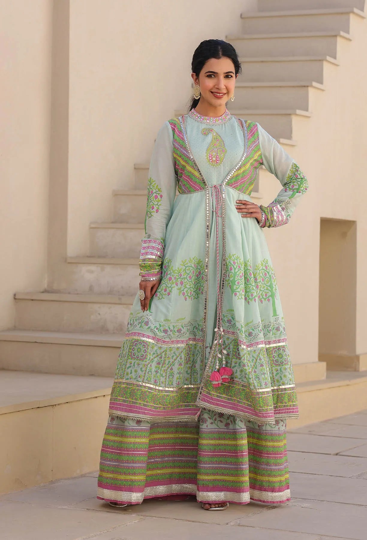 Woman wearing a traditional outfit with floral patterns on a staircase background