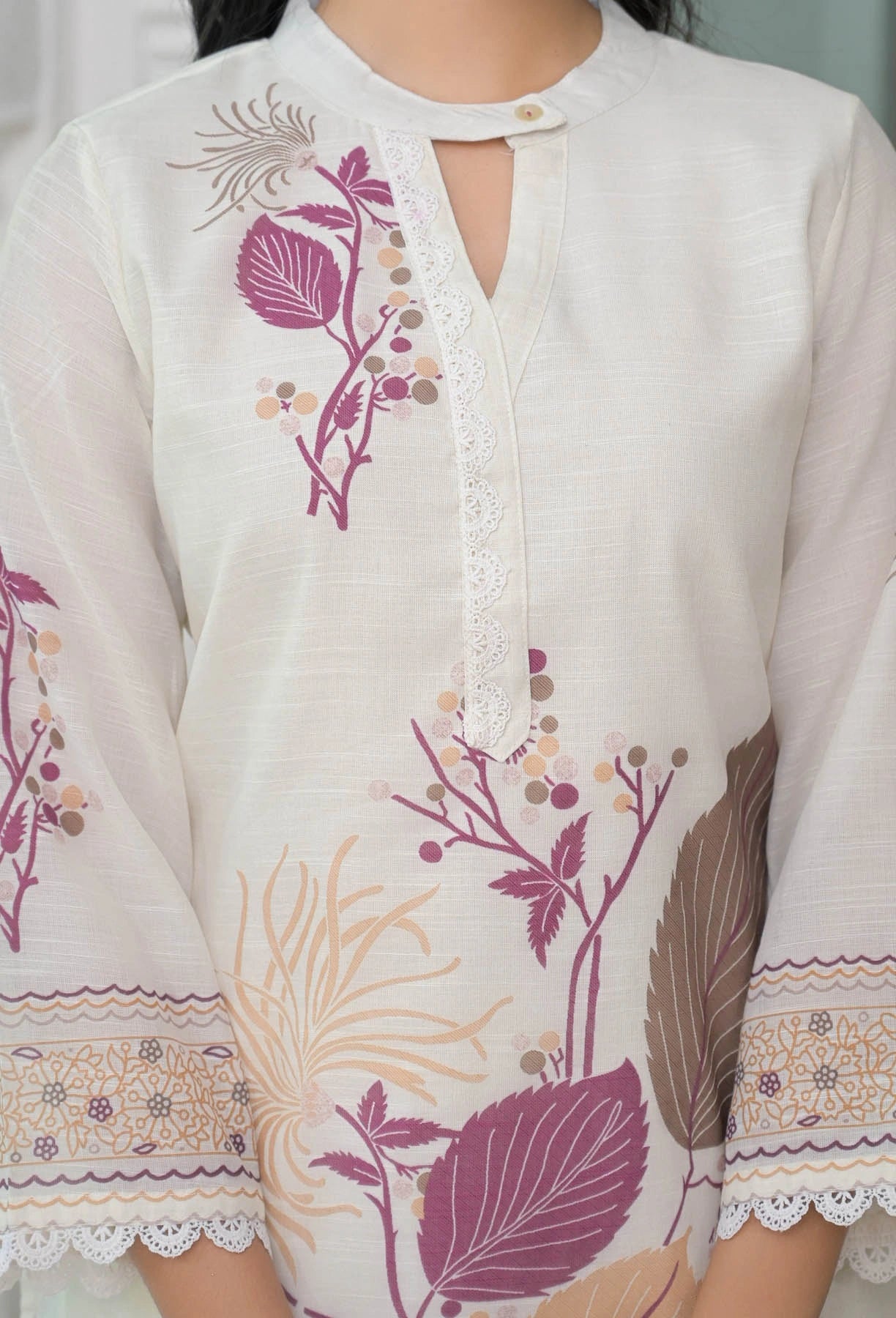 White garment with floral embroidery and lace details