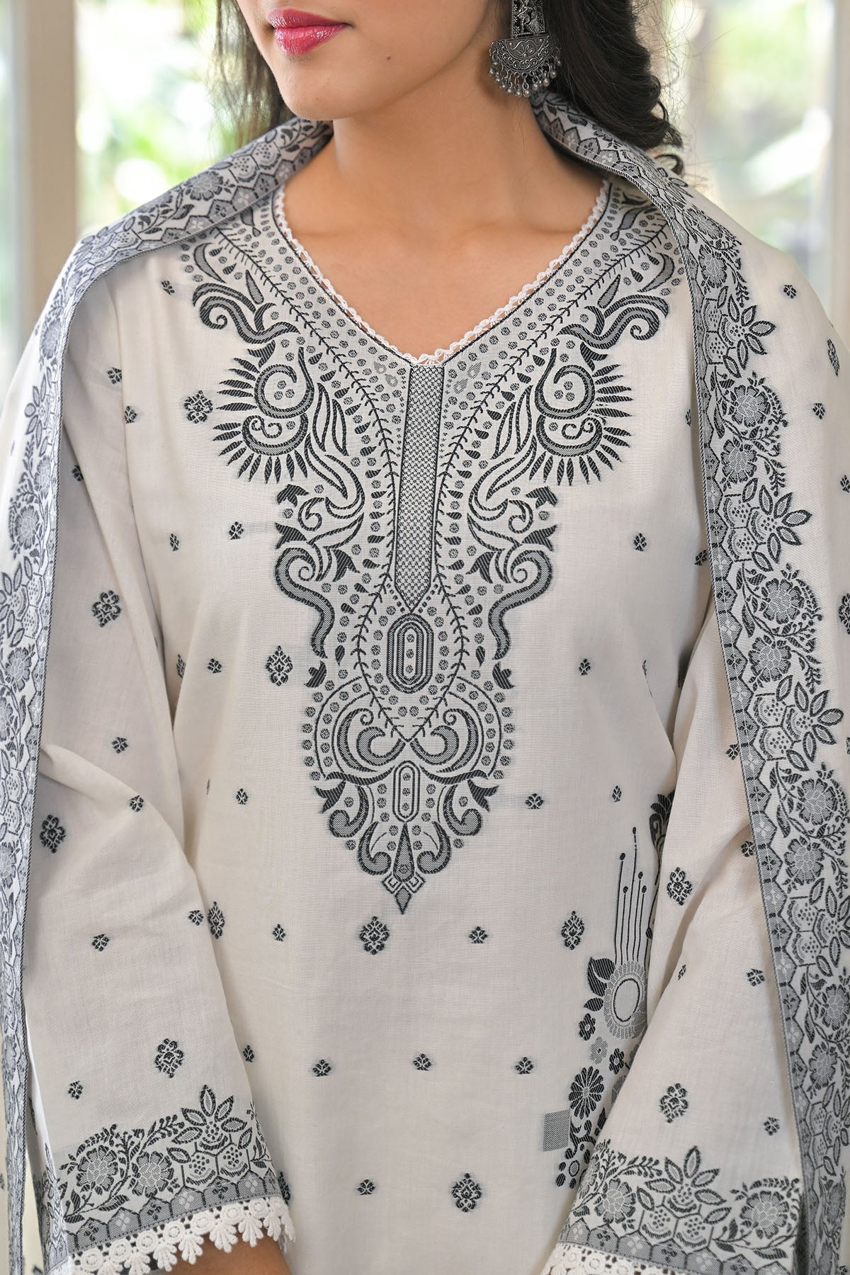 White embroidered traditional outfit with black patterns