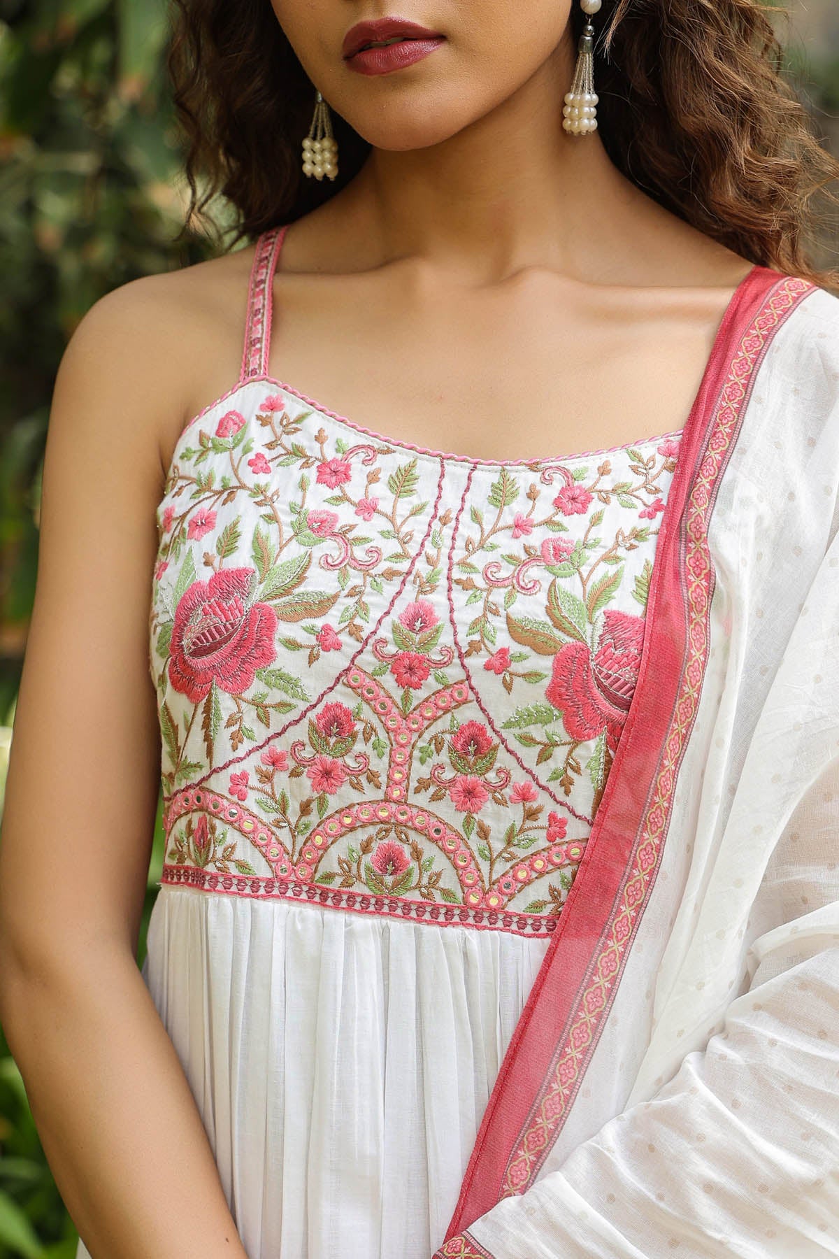 White saree with pink and green floral embroidery