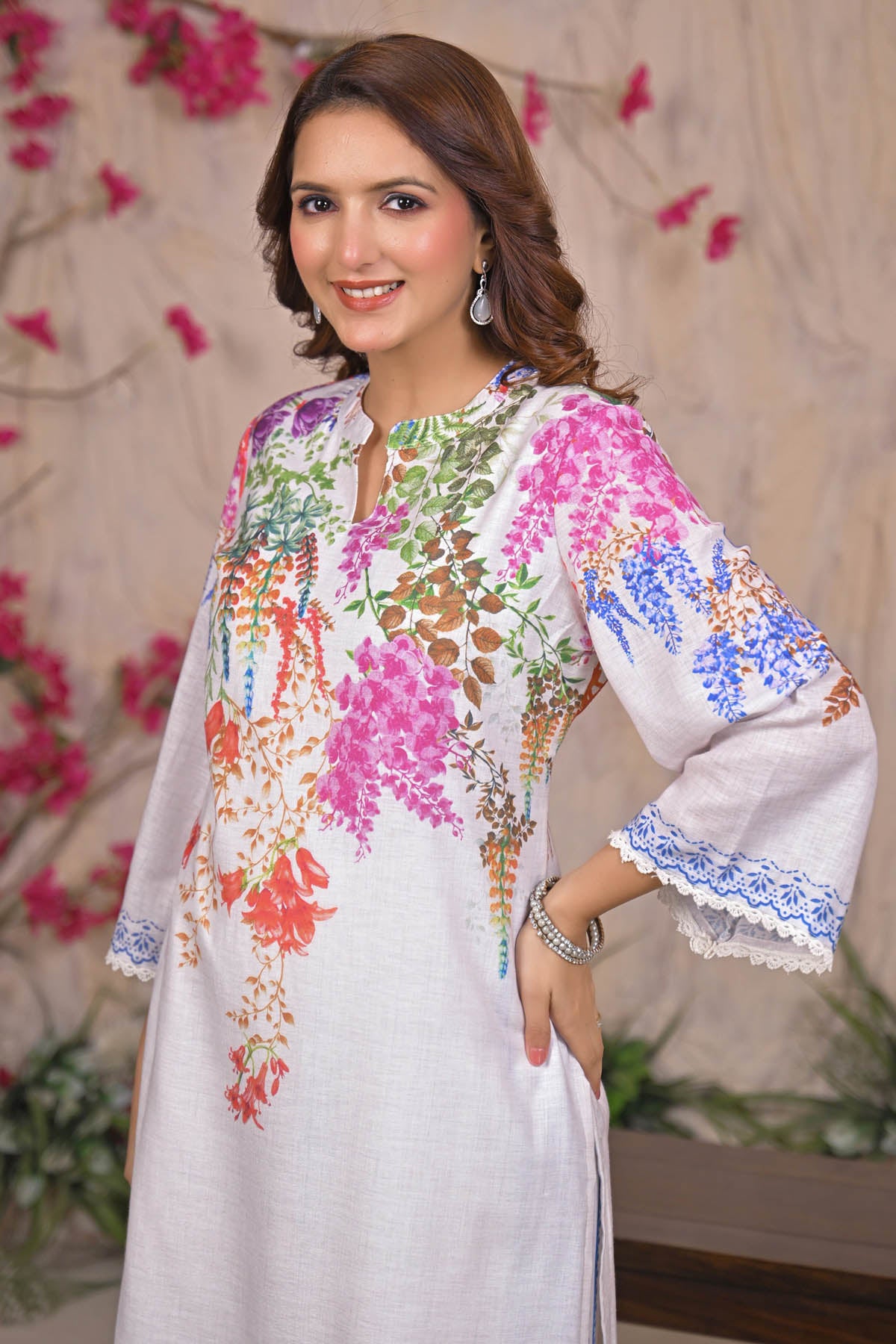 Woman wearing a colorful floral dress with a decorative background