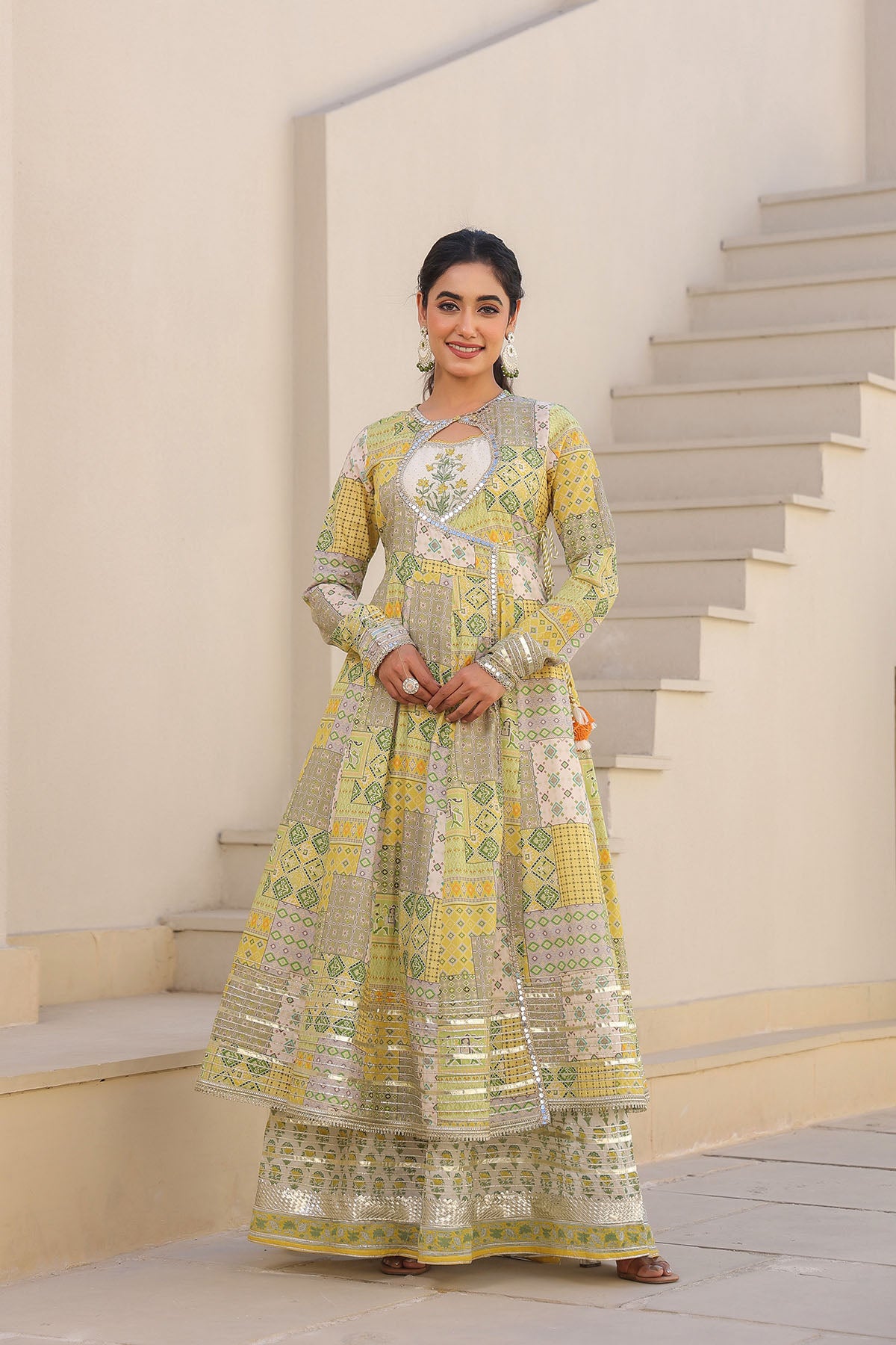 Woman in a traditional outfit standing on a staircase
