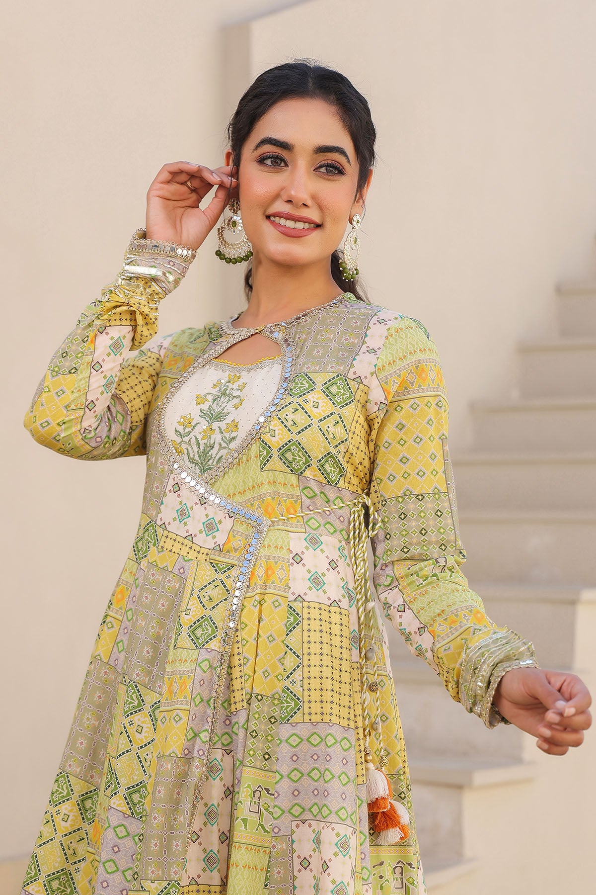 Woman wearing a patterned dress with a neutral background