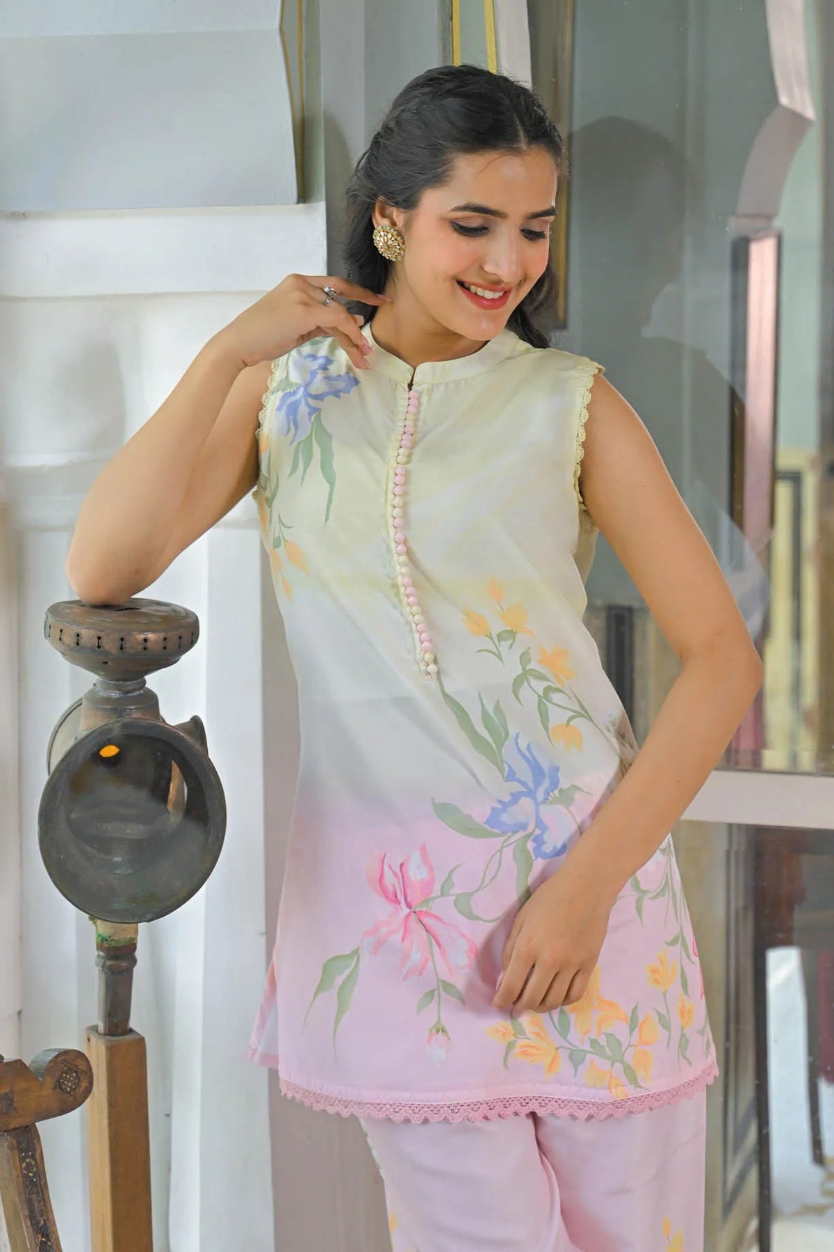Woman wearing a light-colored floral dress indoors